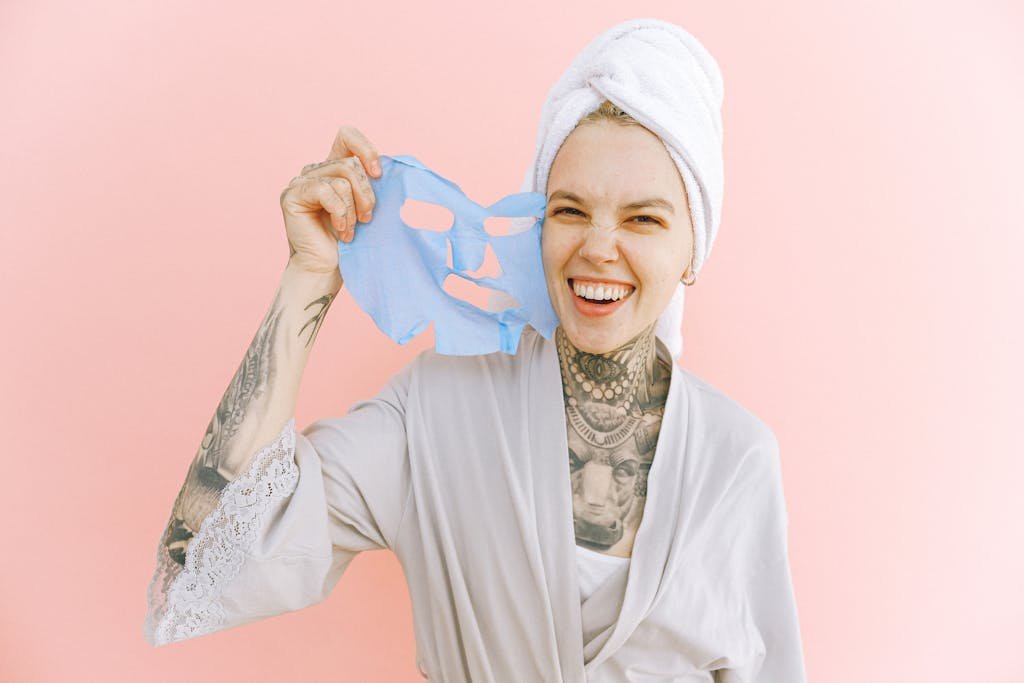 Happy woman removing face mask after taking bath