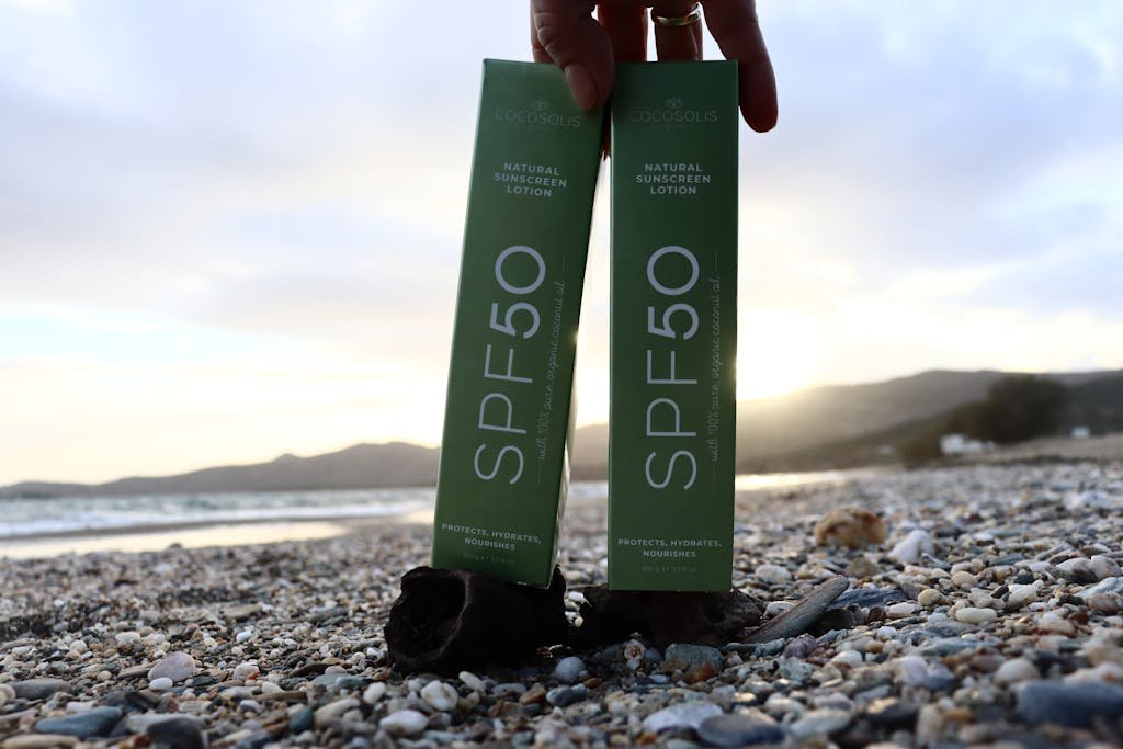 Packaging with Sunscreen on the Ground on the Beach