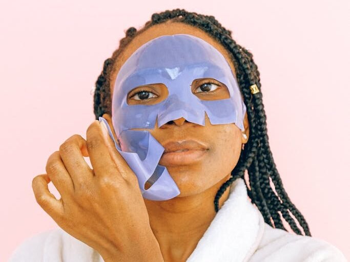 Woman In White Robe With White Face Mask